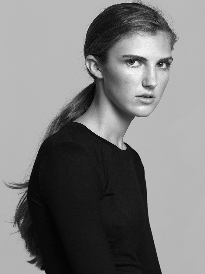 Portrait of model Dalanney Stone in black long-sleeved shirt photographed in black and white by Joshua Pyles