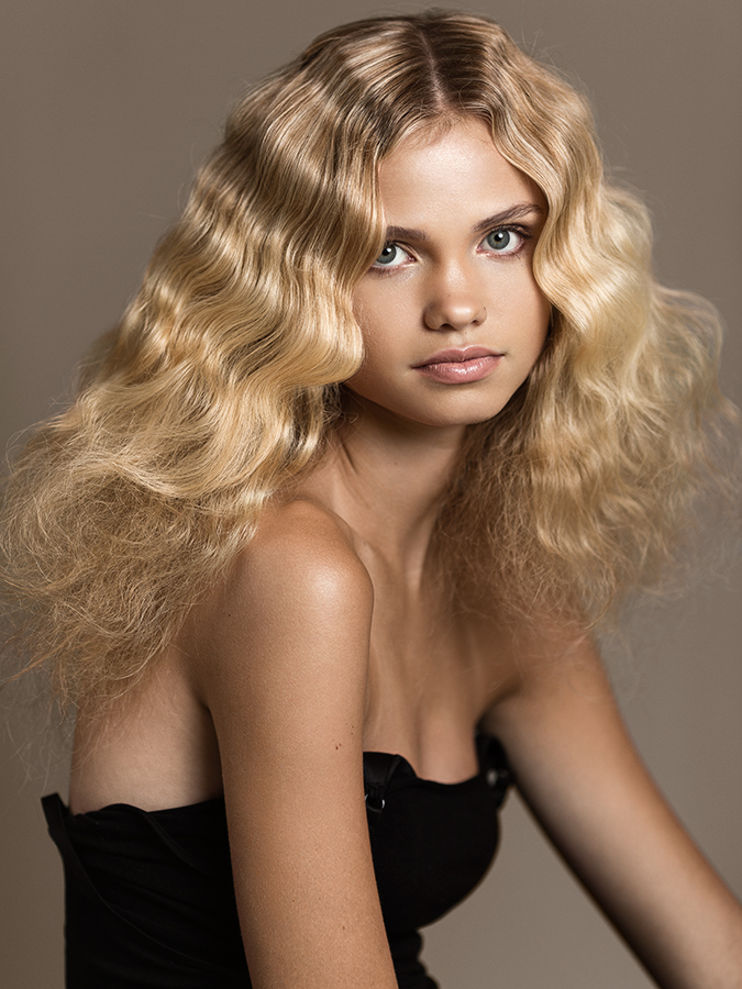 Portait of young blonde model Grace Mikula with glamorous wavy hair photographed by Joshua Pyles