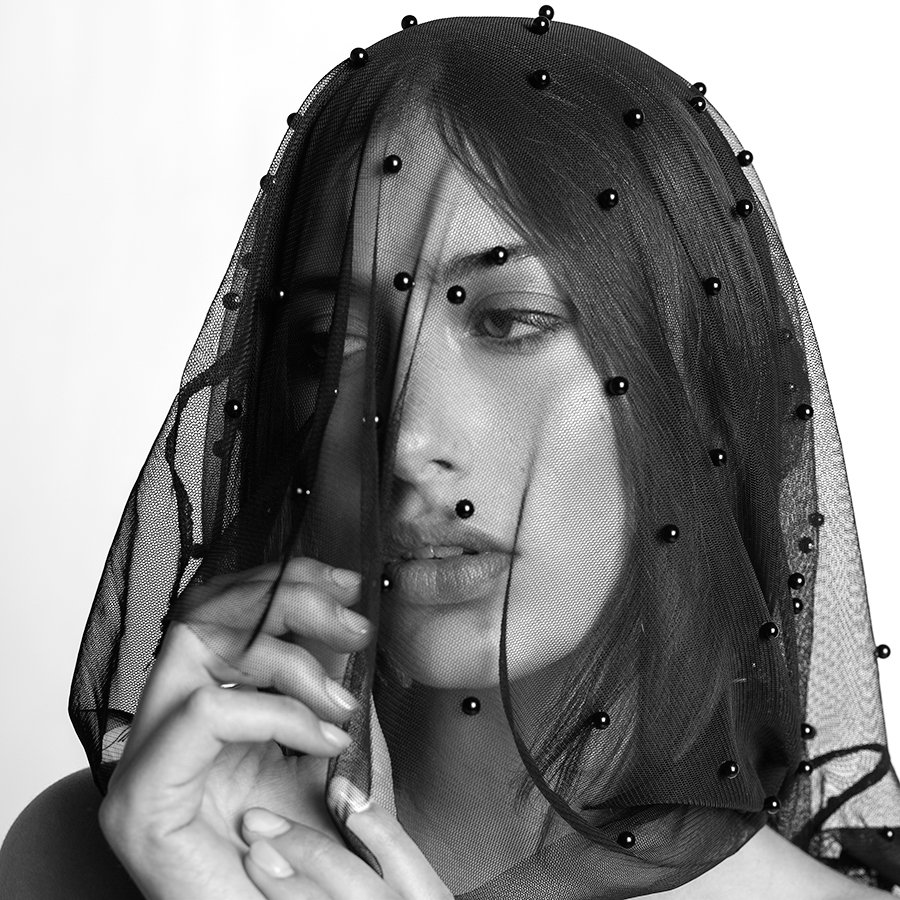 Black and white headshot of model Haley Mick with a beaded veil over her head photographed by Joshua Pyles