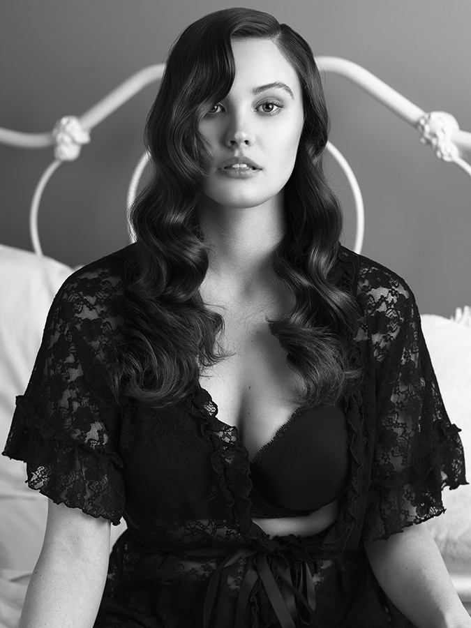 Model Kimberly Froelich in a bra and lacy lingerie kimono photographed on a bed with vintage iron bedframe by Joshua Pyles