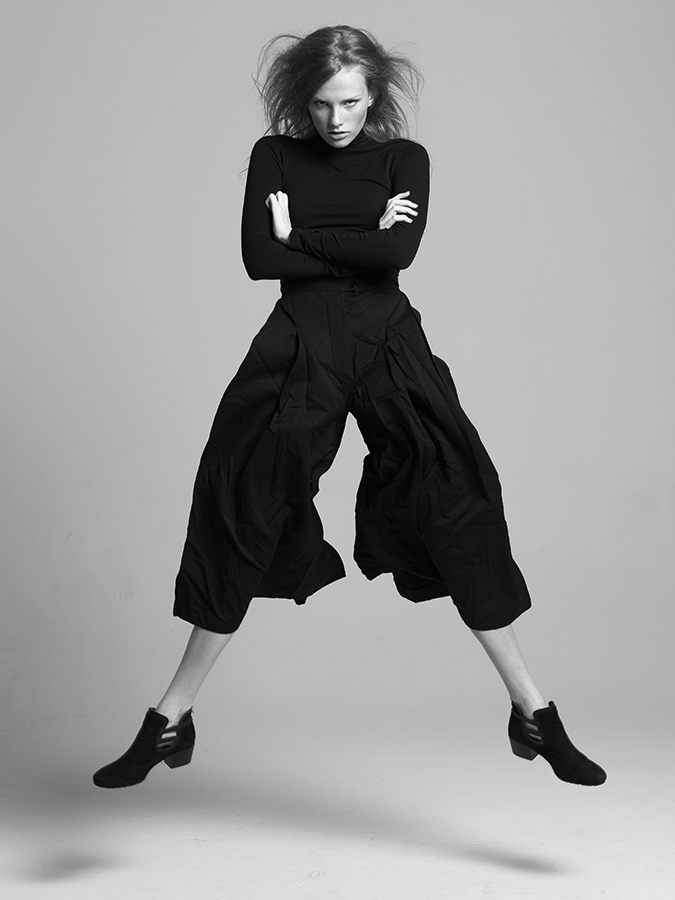 Next model Sarah Grace Pugh jumping in air in flowing black outfit photographed by Joshua Pyles
